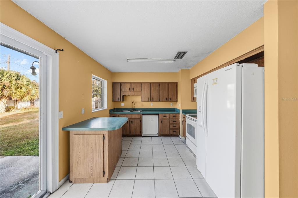 2701 Southwest 15th Street Ocala, FL 34474 - Photo 18 of 38 a kitchen with stainless steel appliances granite countertop a refrigerator and a sink
