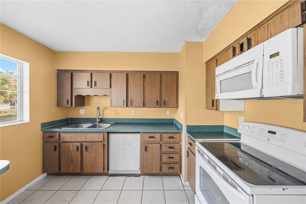 2701 Southwest 15th Street Ocala, FL 34474 - Photo 20 of 38 a kitchen with a sink stove and cabinets