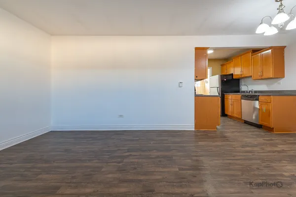 a view of a kitchen with wooden floor and a sink