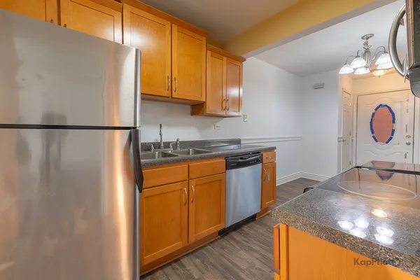 a kitchen with stainless steel appliances granite countertop a sink a stove and a microwave oven with granite countertops
