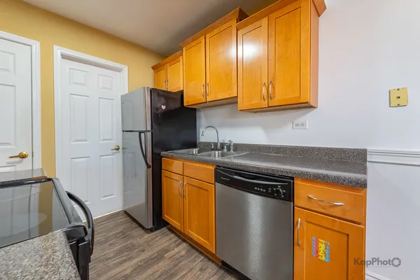 a kitchen with stainless steel appliances granite countertop a stove a sink and a refrigerator