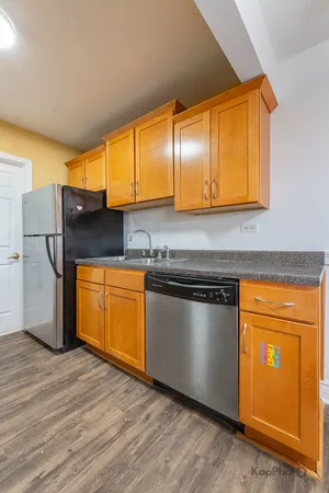 a kitchen with stainless steel appliances granite countertop a stove a microwave and a refrigerator