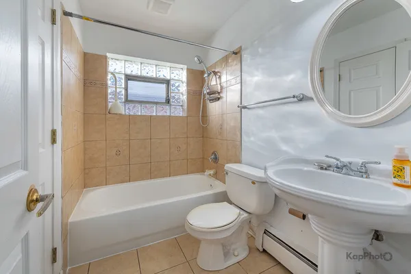 a bathroom with a toilet a sink and bathtub