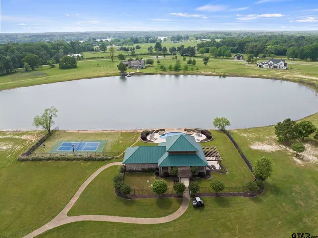 a view of a lake with houses in the back