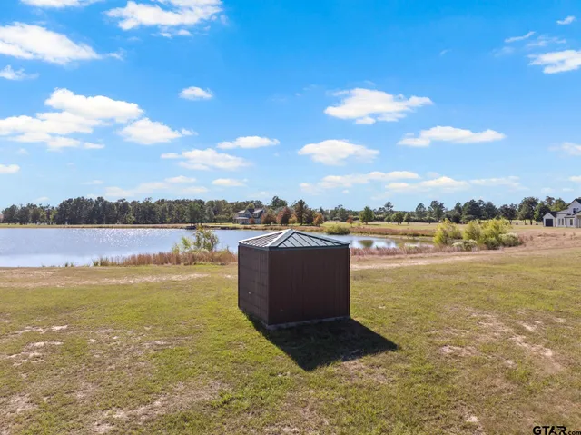 a view of a lake with houses in the background
