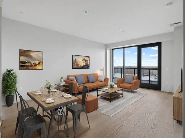 a living room with furniture and a floor to ceiling window