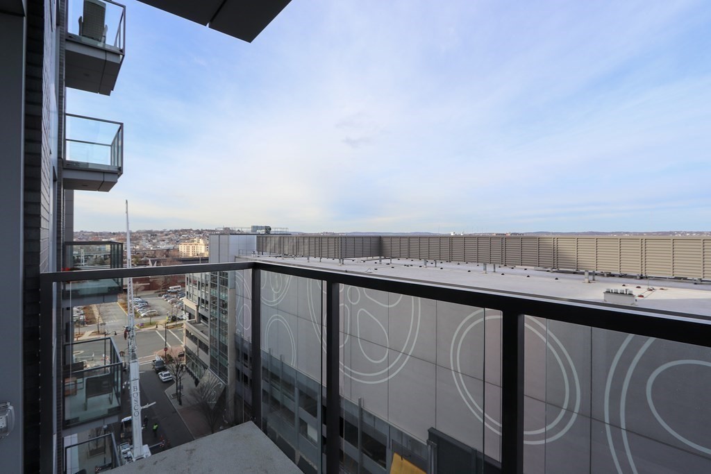 375 Canal Street, Unit 812 Somerville, MA 02145 - Photo 14 of 20 a view of a balcony with furniture and wooden floor