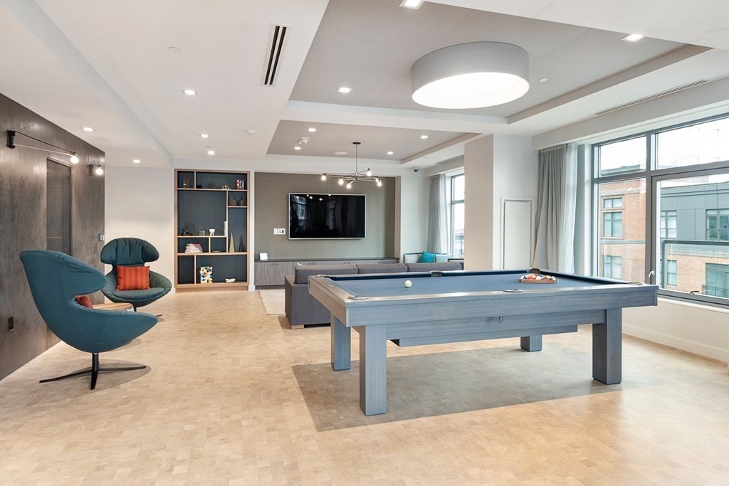 375 Canal Street, Unit 812 Somerville, MA 02145 - Photo 16 of 20 a living room with furniture a flat screen tv and a large window