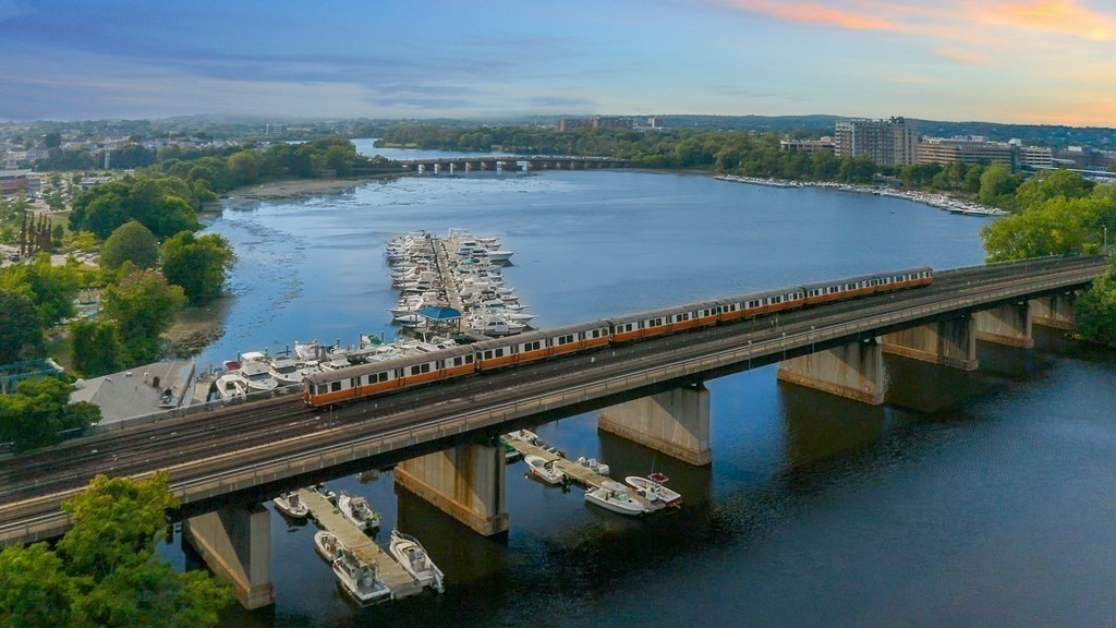 375 Canal Street, Unit 812 Somerville, MA 02145 - Photo 19 of 20 a view of swimming pool with seating area and trees in the background