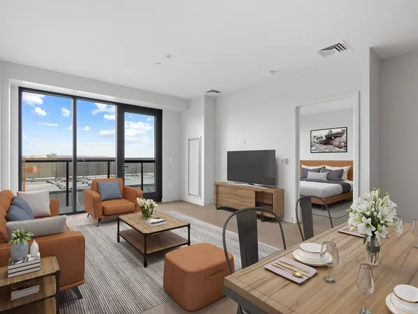a living room with furniture and a floor to ceiling window