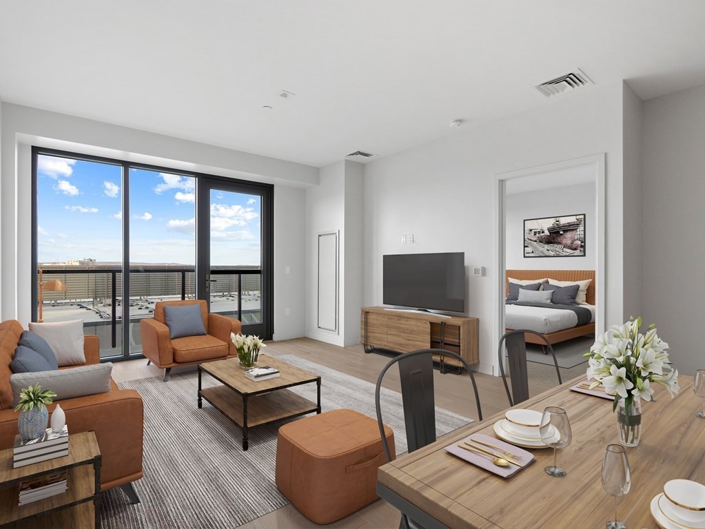 375 Canal Street, Unit 812 Somerville, MA 02145 - Photo 2 of 20 a living room with furniture and a floor to ceiling window