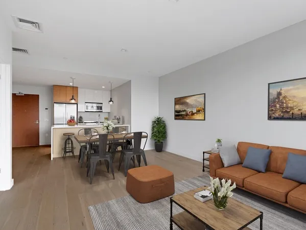 a living room with furniture kitchen view and a dining table