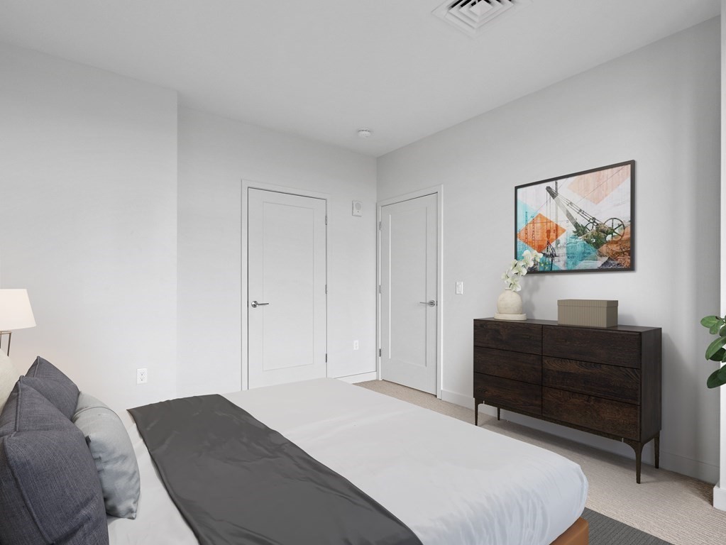 375 Canal Street, Unit 812 Somerville, MA 02145 - Photo 10 of 20 a bedroom with a bed and paintings on the wall