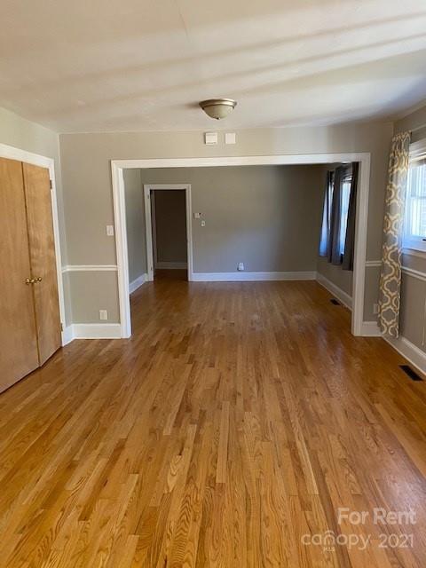 14315 Ramah Church Road Huntersville, NC 28078 - Photo 15 of 32 a view of an empty room with wooden floor and a window