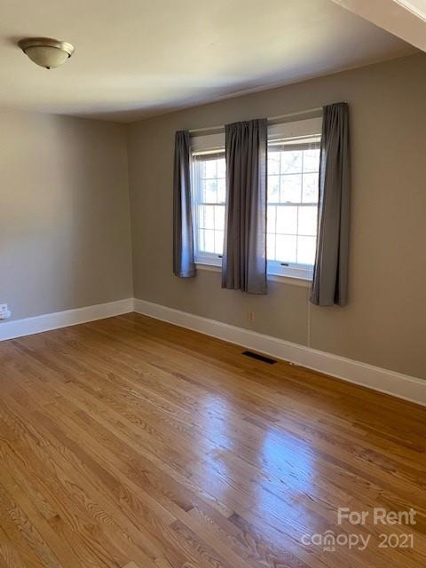 14315 Ramah Church Road Huntersville, NC 28078 - Photo 16 of 32 an empty room with wooden floor and windows