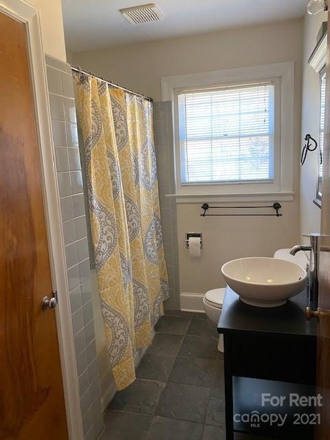 14315 Ramah Church Road Huntersville, NC 28078 - Photo 18 of 32 a bathroom with a sink a toilet a window and shower