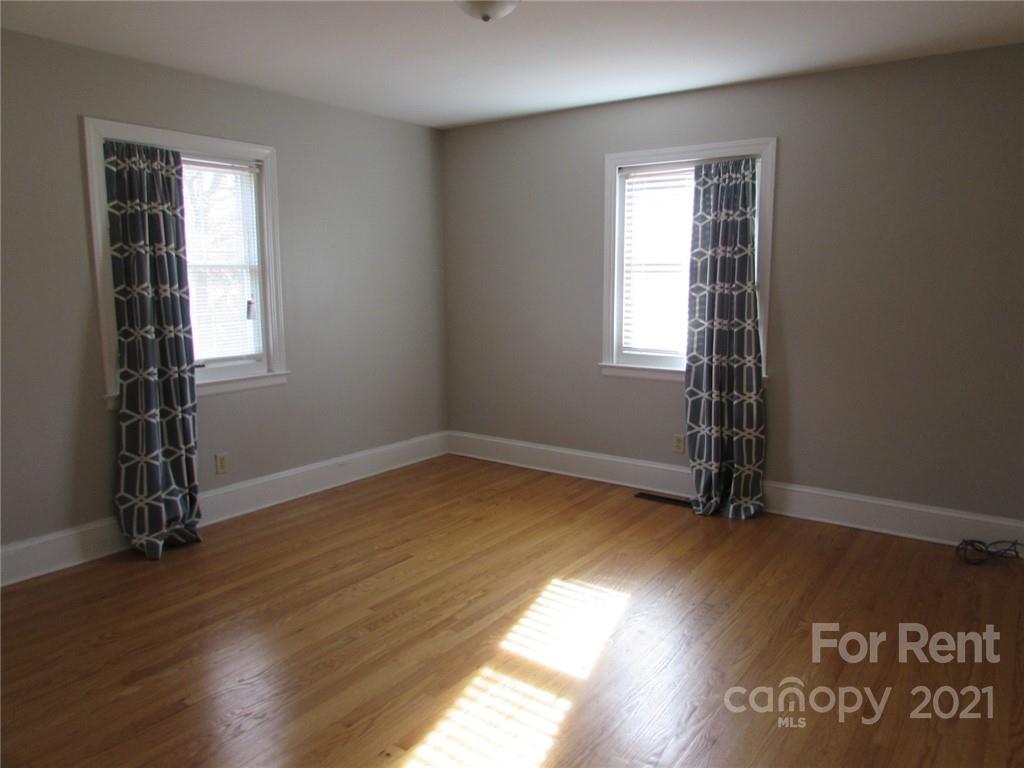14315 Ramah Church Road Huntersville, NC 28078 - Photo 20 of 32 an empty room with wooden floor and windows