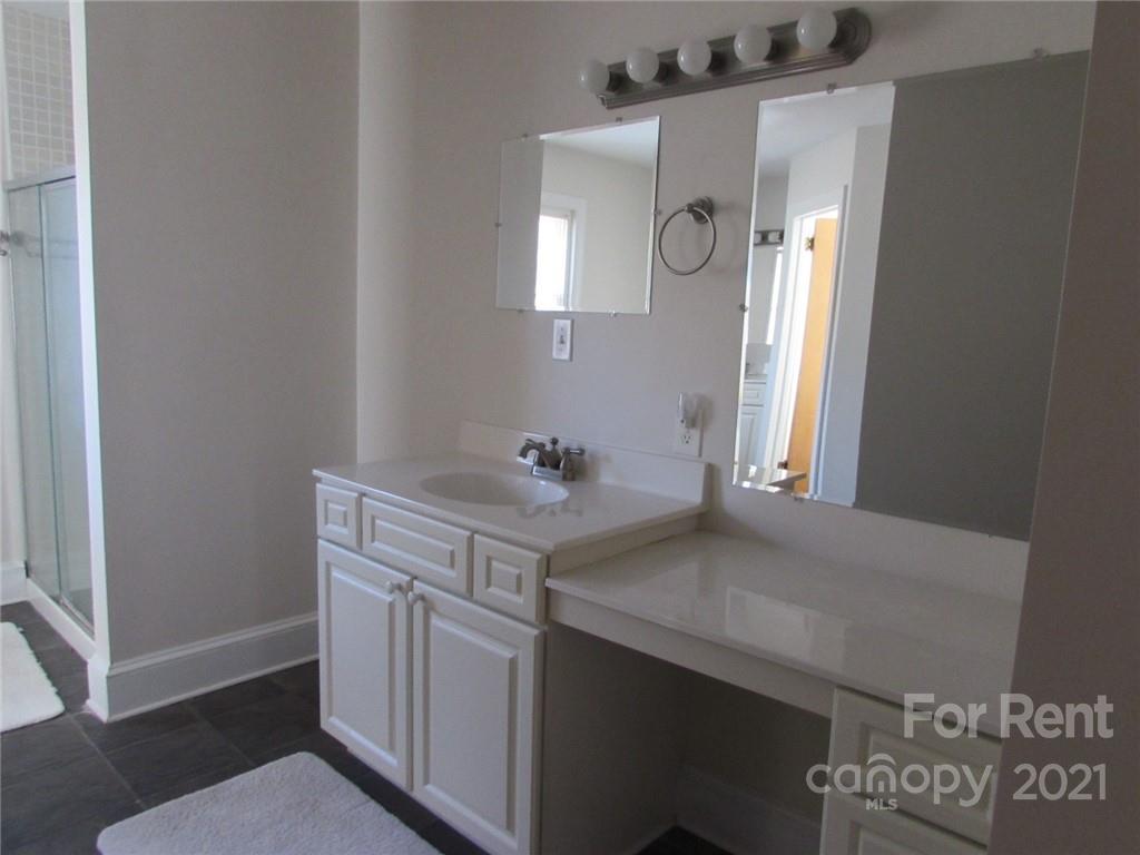 14315 Ramah Church Road Huntersville, NC 28078 - Photo 22 of 32 a bathroom with a sink vanity and a mirror