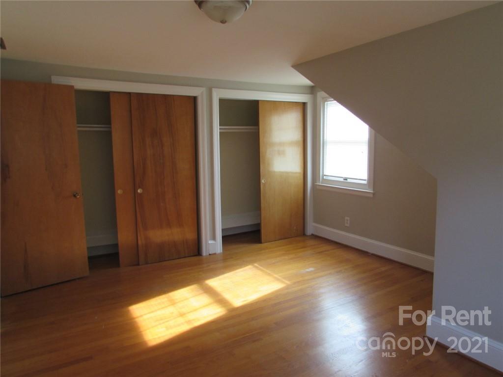 14315 Ramah Church Road Huntersville, NC 28078 - Photo 28 of 32 an empty room with wooden floor and windows
