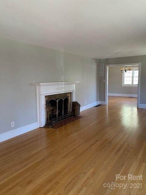 14315 Ramah Church Road Huntersville, NC 28078 - Photo 6 of 32 a view of empty room with wooden floor and fireplace