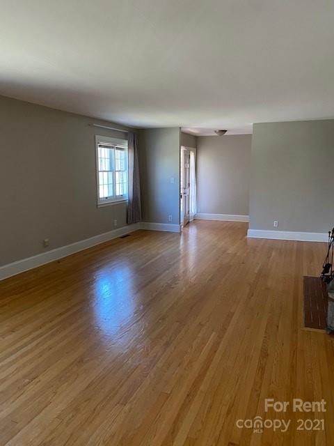 14315 Ramah Church Road Huntersville, NC 28078 - Photo 8 of 32 an empty room with wooden floor and windows