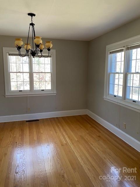 14315 Ramah Church Road Huntersville, NC 28078 - Photo 9 of 32 an empty room with wooden floor and windows