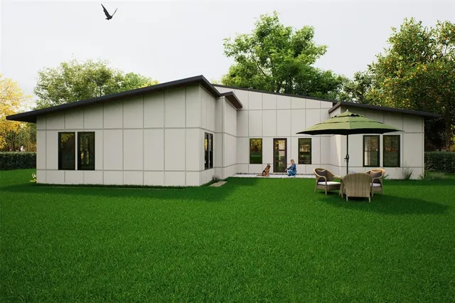 a backyard of a house with table and chairs