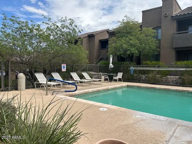 a view of a swimming pool with chairs