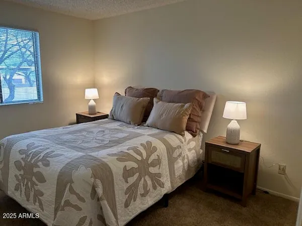 a bedroom with a bed and a lamp