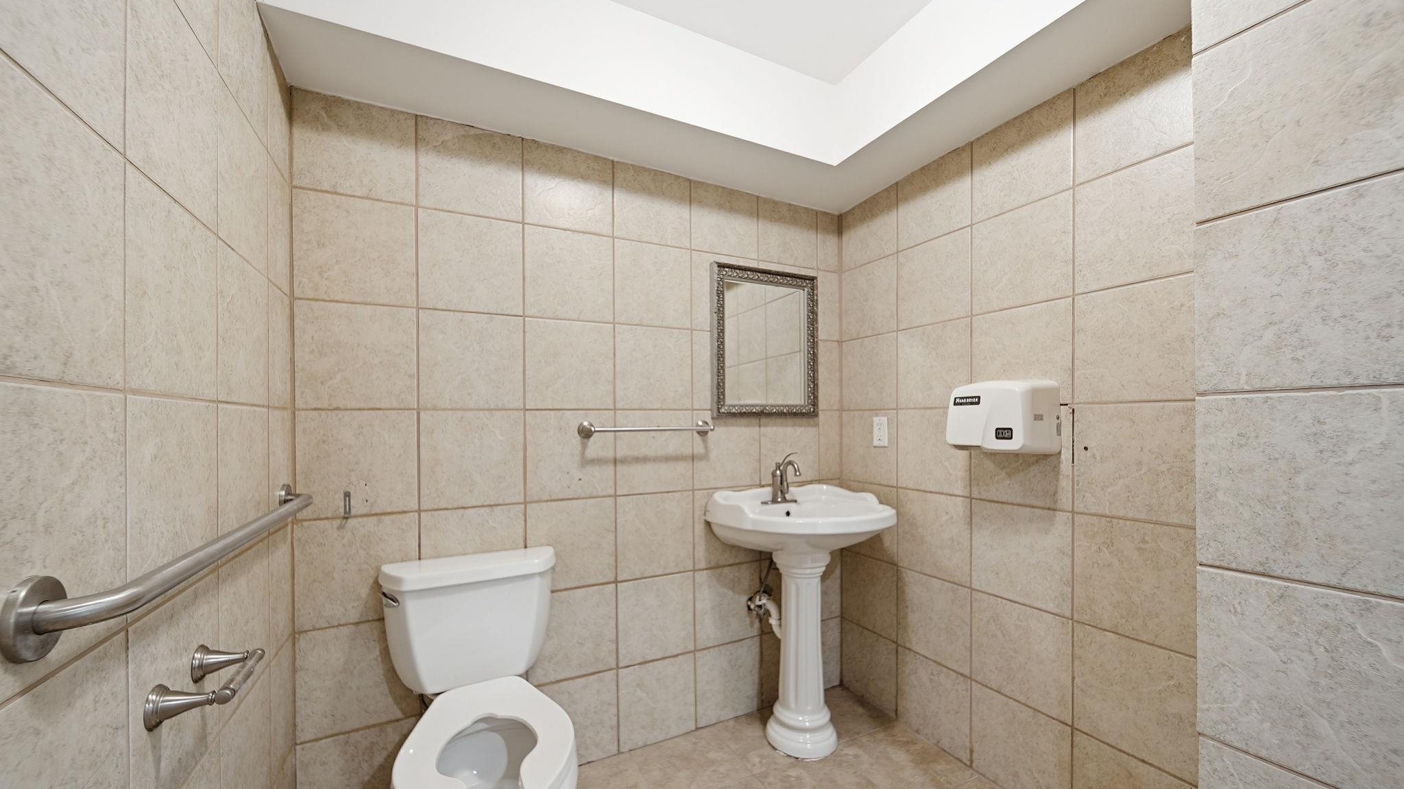 8637 Highway 59 Burlison, TN 38015 - Photo 7 of 37 a bathroom with a toilet sink and mirror