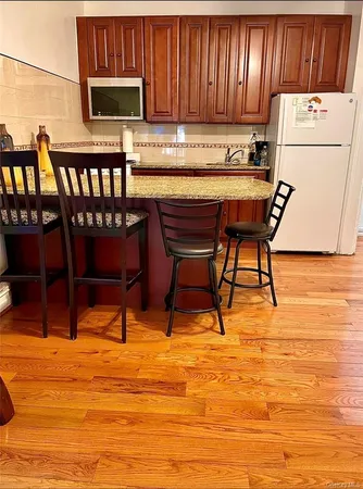 a kitchen with stainless steel appliances wooden cabinets a stove top oven a sink and dishwasher