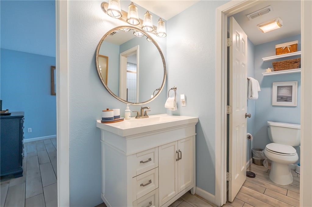 2292 North Fulton Beach Road, Unit 405 Rockport, TX 78382 - Photo 20 of 40 a bathroom with a toilet a sink and a mirror
