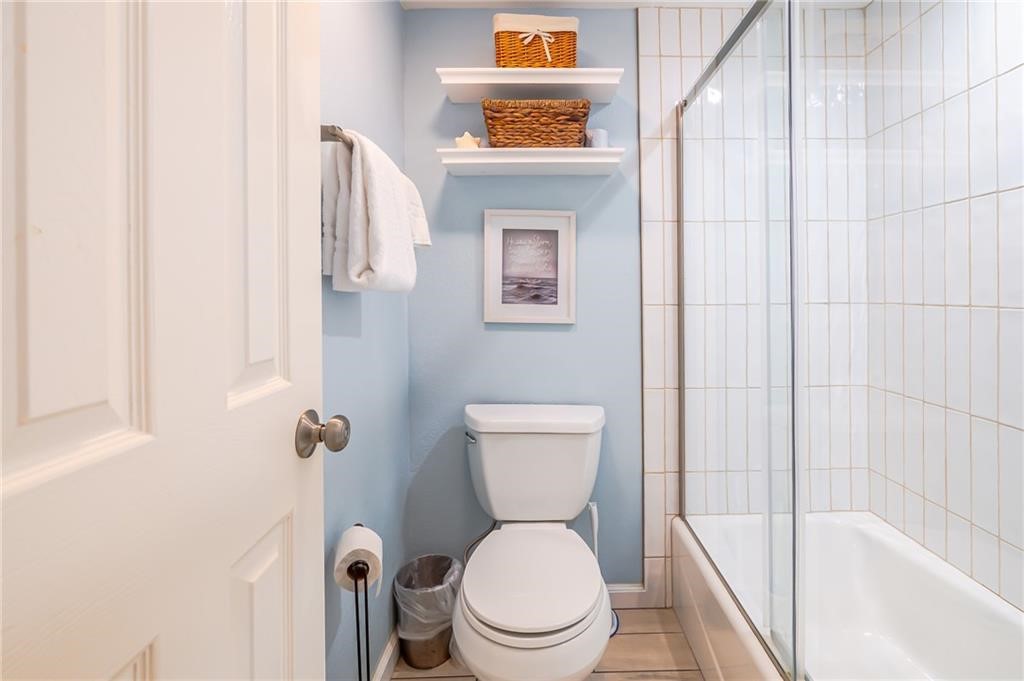 2292 North Fulton Beach Road, Unit 405 Rockport, TX 78382 - Photo 22 of 40 a white toilet sitting next to a bathroom sink