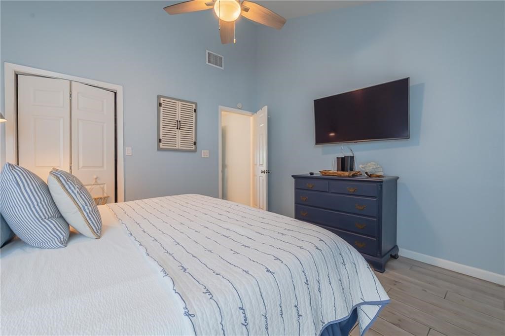 2292 North Fulton Beach Road, Unit 405 Rockport, TX 78382 - Photo 28 of 40 a bedroom with a bed and a flat screen tv