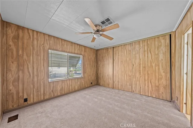 a view of a room with a ceiling fan