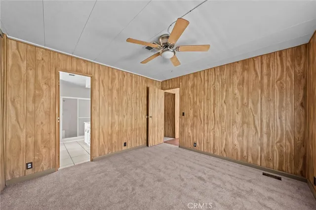 a spacious bathroom with a granite countertop sink a mirror and a bathtub