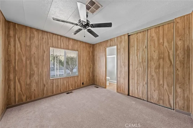 an empty room with ceiling fan