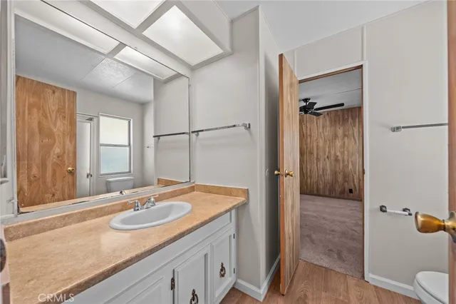 a spacious bathroom with a granite countertop sink and a mirror