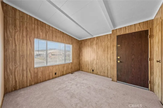 a view of an empty room with wooden walls