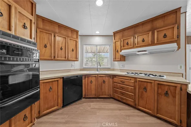 a kitchen with stainless steel appliances granite countertop a stove and a refrigerator