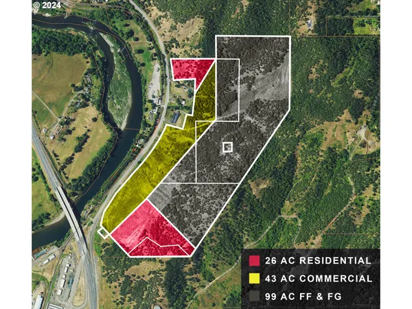 an aerial view of residential houses with outdoor space and trees