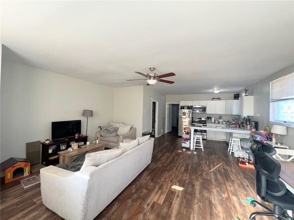 1039 State Avenue, Unit 1039 Coraopolis, PA 15108 - Photo 2 of 6 a living room with furniture and a flat screen tv