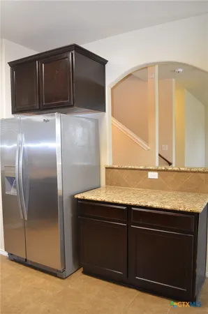 a kitchen with granite countertop a cabinets and stainless steel appliances