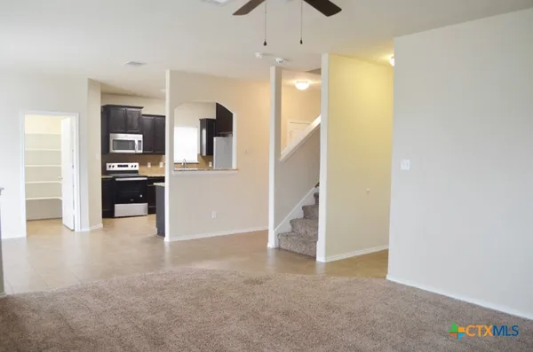 a view of a hallway view with wooden floor and staircase