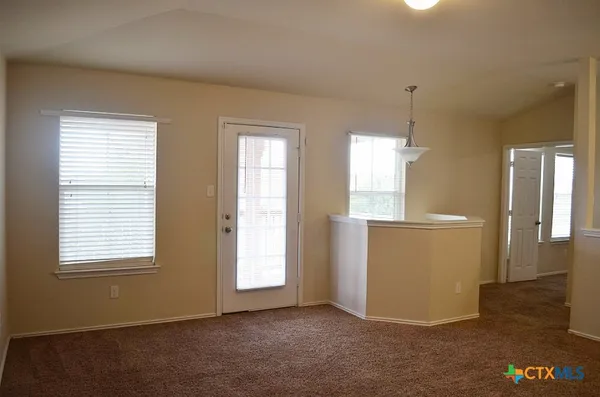 a view of an empty room with a window