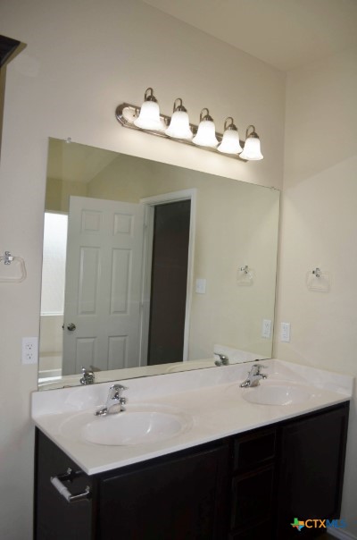 4808 Green Meadow Street Killeen, TX 76549 - Photo 31 of 46 a bathroom with a sink and a mirror