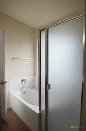 a bathroom with a bathtub and a shower