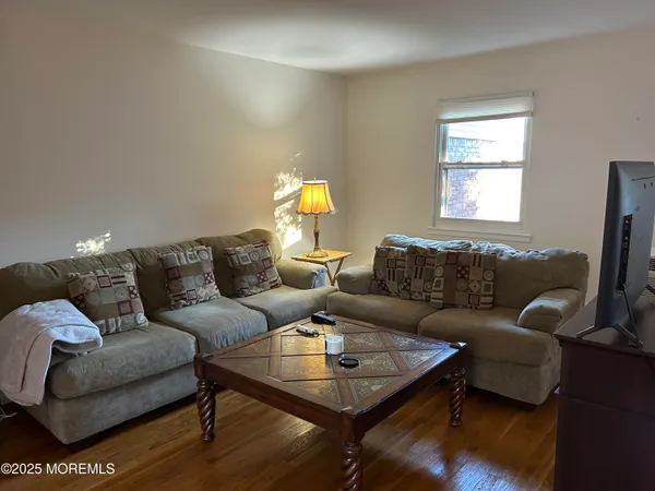 a living room with furniture a rug and a window