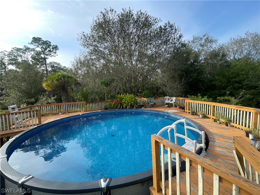 a view of a chairs and table on the roof deck