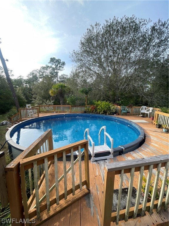 5320 8th Street Clewiston, FL 33440 - Photo 15 of 18 a view of a swimming pool with a lounge chair